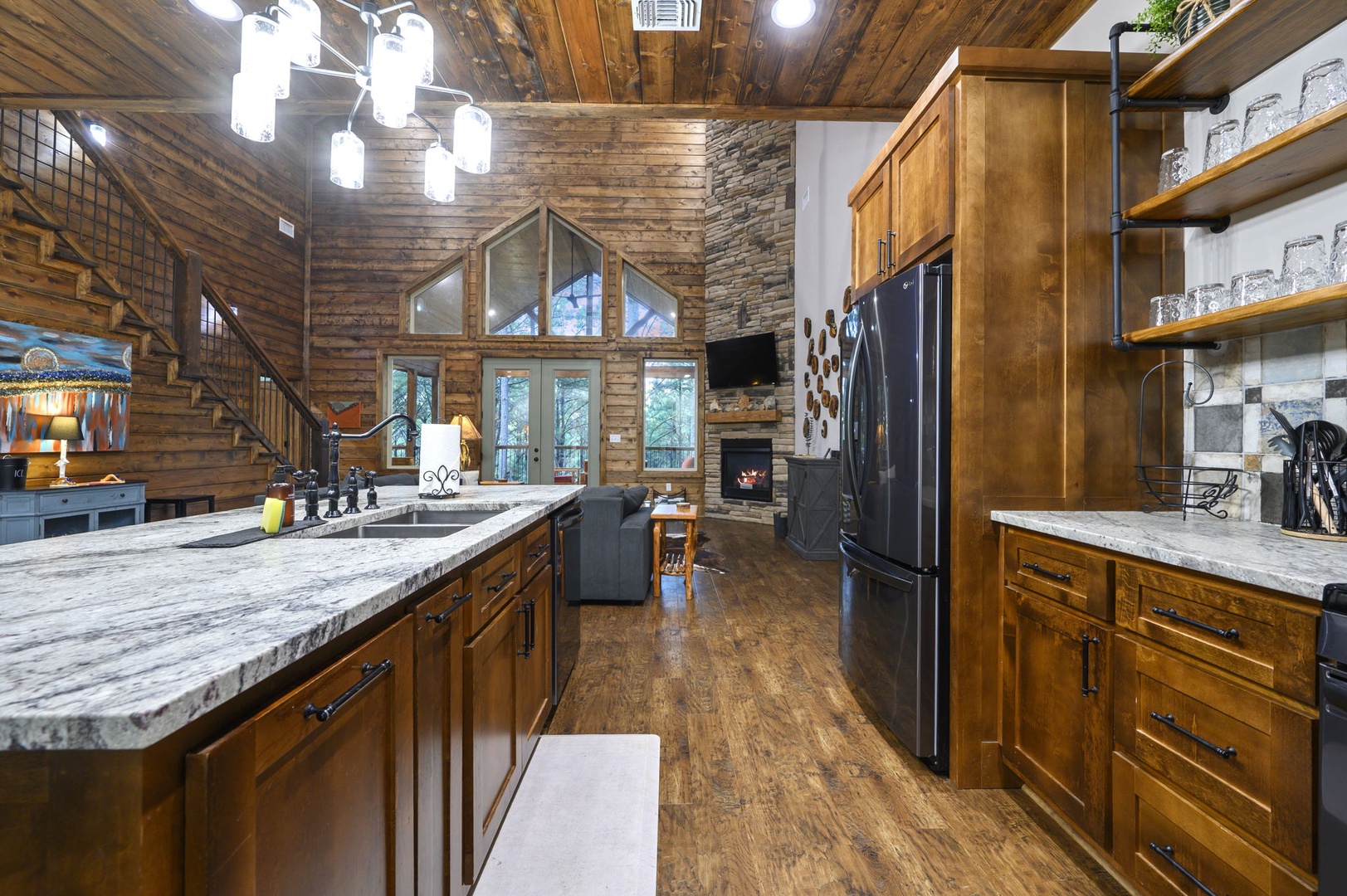 Step into your mountain retreat with soaring vaulted ceilings and warm wood details. Your gourmet kitchen features granite counters and modern appliances, flowing into a cozy living space with stone fireplace and loft above.