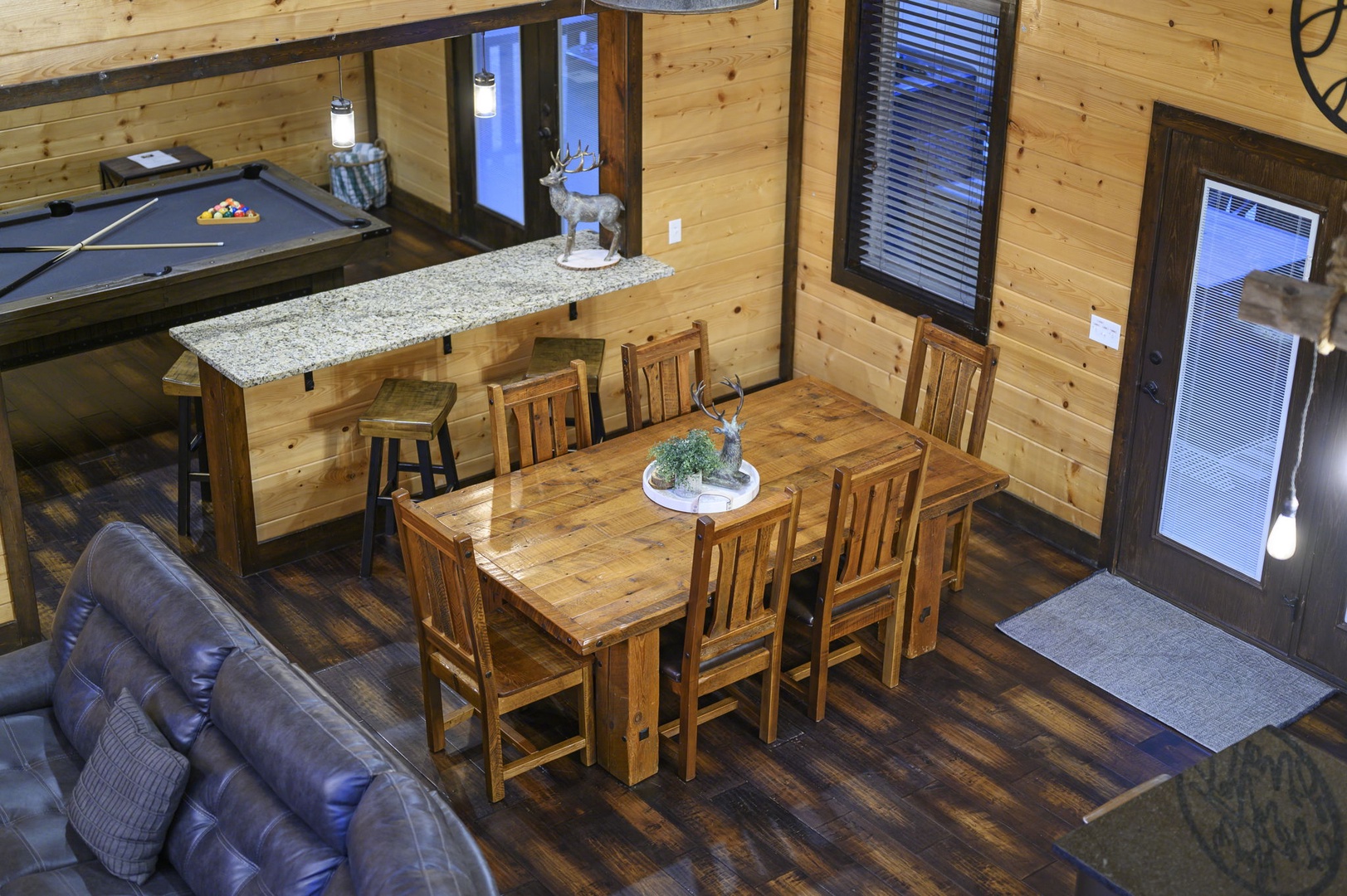 Gather for meals at the handcrafted wooden dining table, or challenge friends to a game of billiards in your cabin's open living space with soaring ceilings.