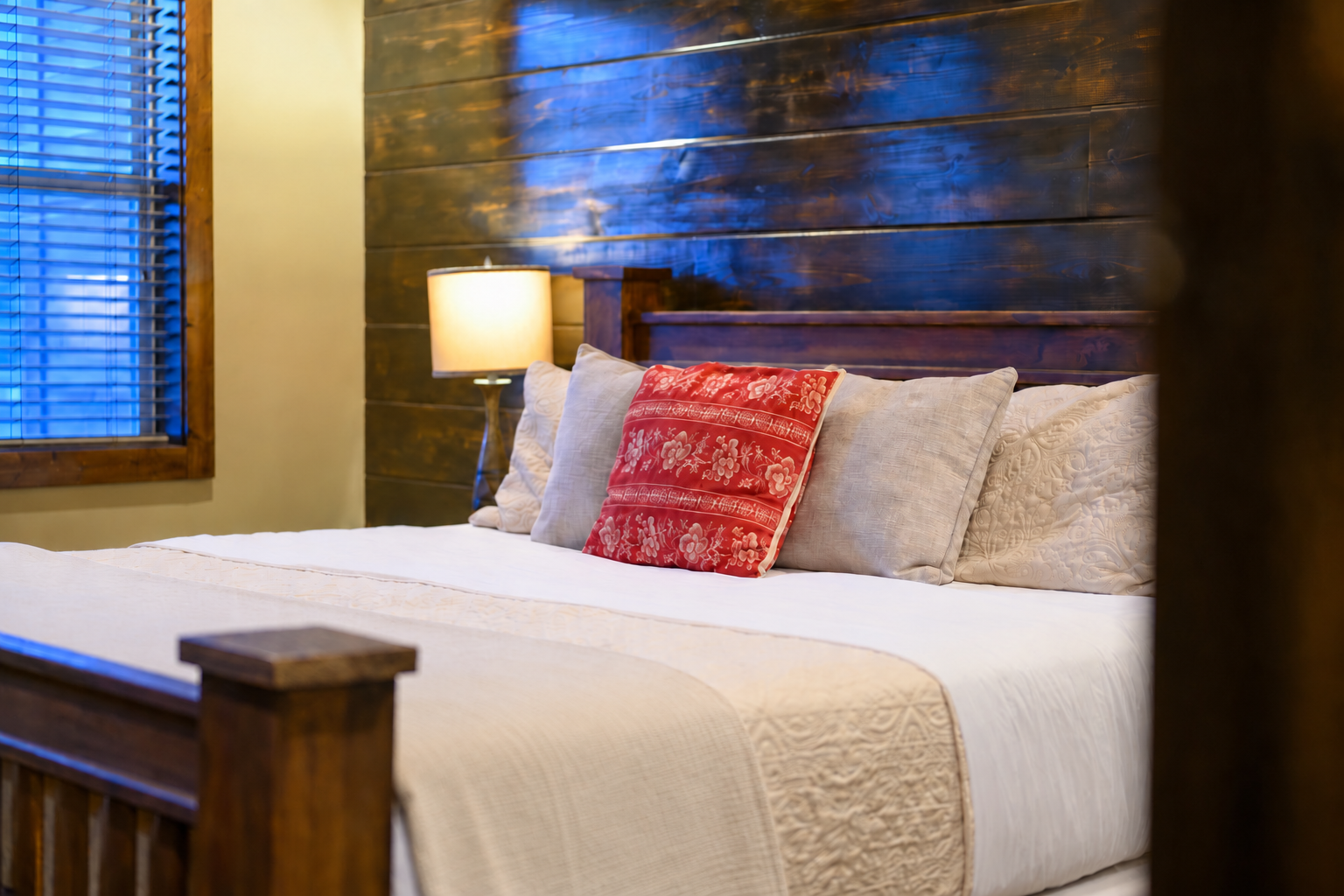 Sink into crisp white linens and plush pillows after a day of exploring. Your cozy retreat features rustic wood accents and warm lighting to help you unwind.