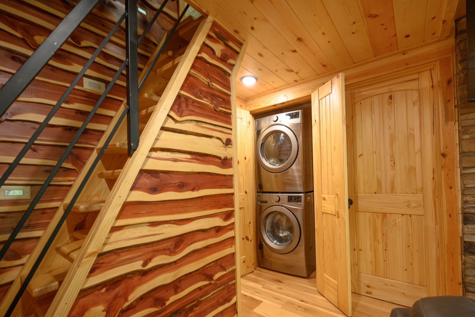 Your own private laundry tucked away in a charming wood-paneled nook, complete with stackable washer and dryer, making longer stays effortlessly convenient.