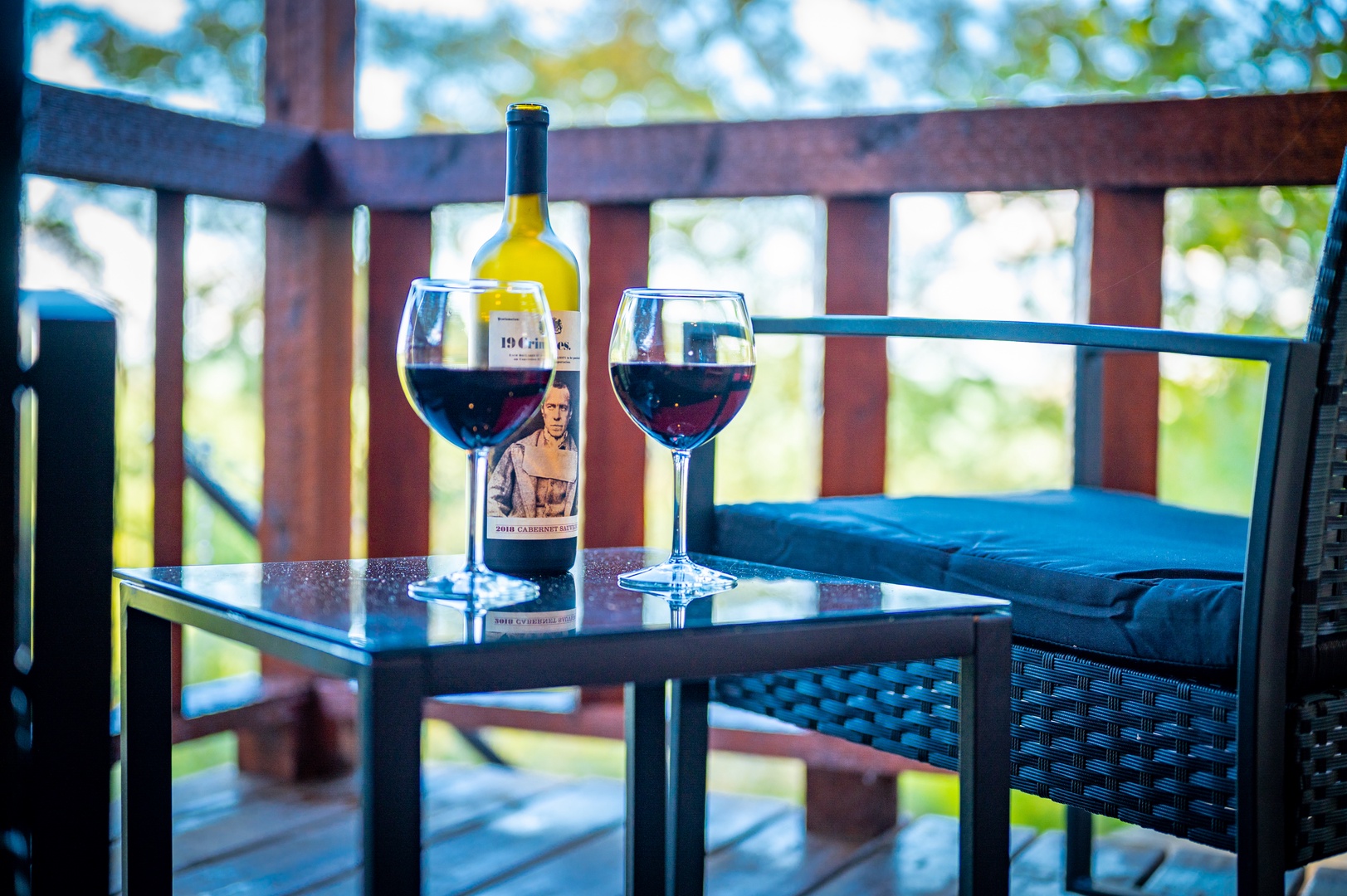 Unwind with your favorite wine on your private balcony, where afternoon light filters through leafy surroundings.