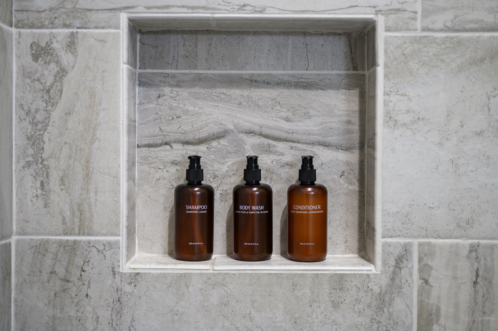 Premium bath essentials await your arrival in this beautifully tiled niche, making your daily routine feel like a spa experience.