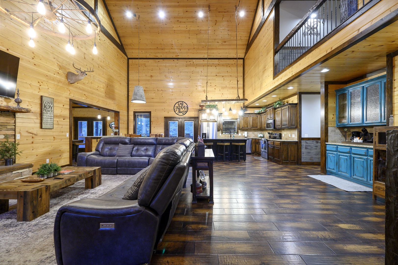 Relax in your expansive open-concept great room where soaring wood-paneled ceilings, rustic decor, and plenty of seating invite you to unwind after exploring the area.
