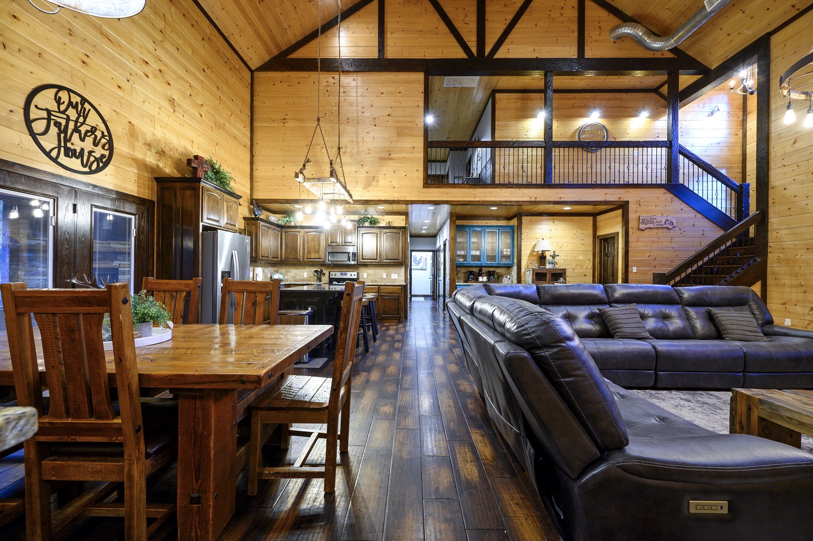 Unwind in this soaring open-concept space where rustic wood meets modern comfort. Gather around the dining table, sink into plush seating, and enjoy the loft's warm glow—your mountain retreat awaits.