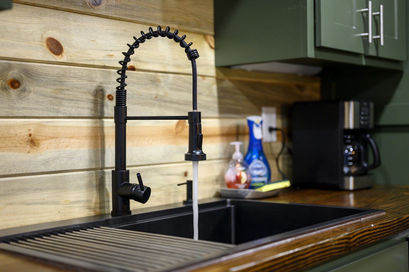 Your sleek kitchen features a professional-style faucet and spacious sink, perfect for preparing meals with style and convenience.