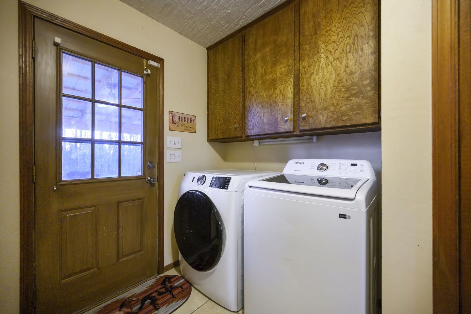 Your dedicated laundry room features full-size washer and dryer with beautiful wood cabinetry for storage convenience.