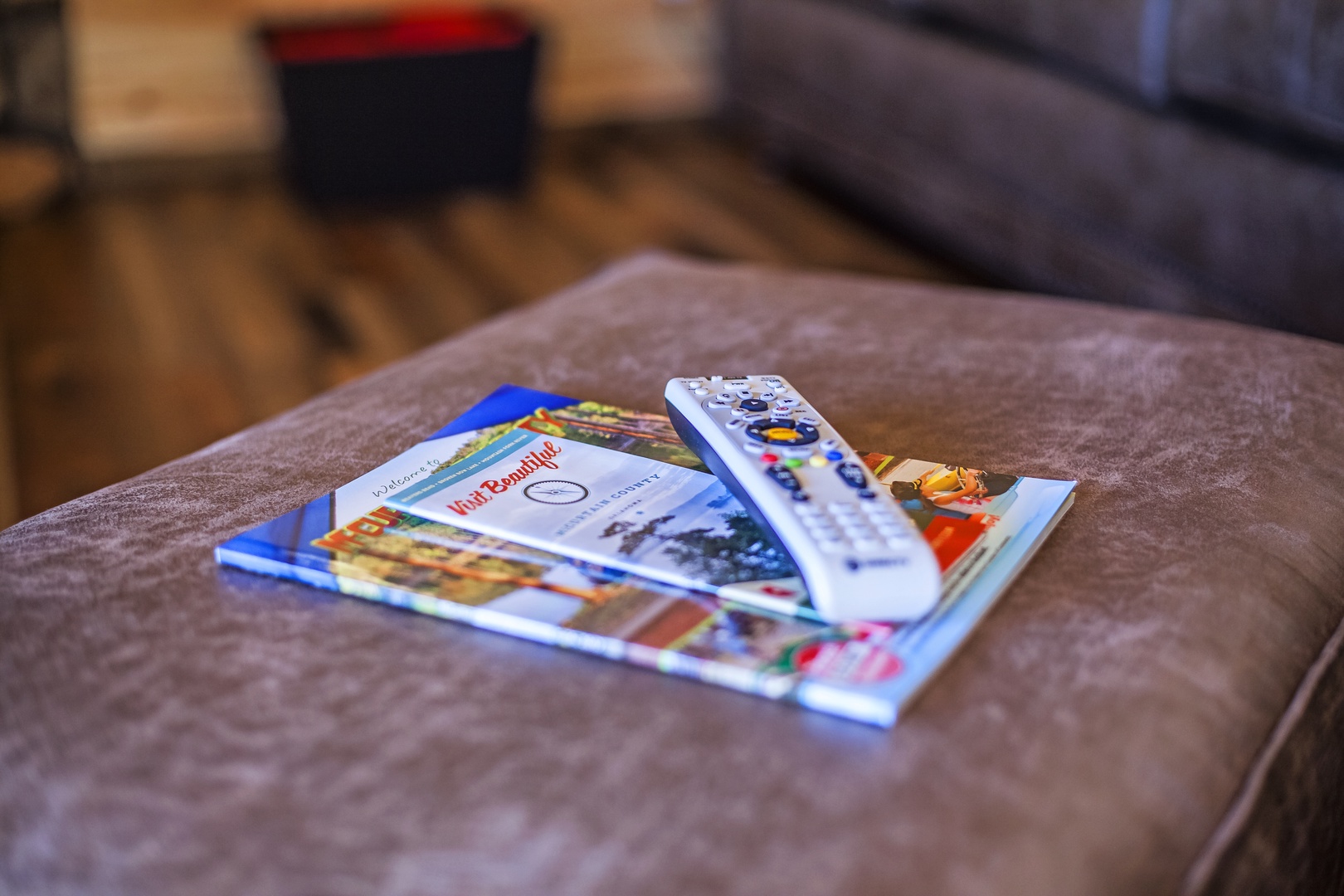 Unwind on your plush sofa with local magazines and entertainment at your fingertips—perfect for planning adventures or cozy nights in.