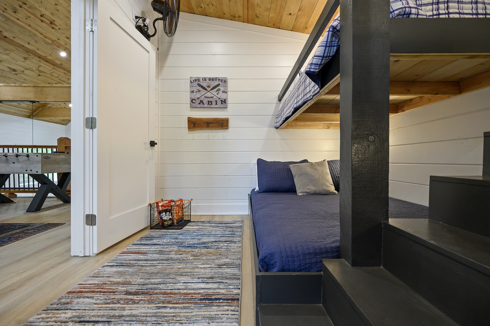 Cozy bunk room where rustic meets modern comfort with plaid linens and charming cabin décor for restful nights.