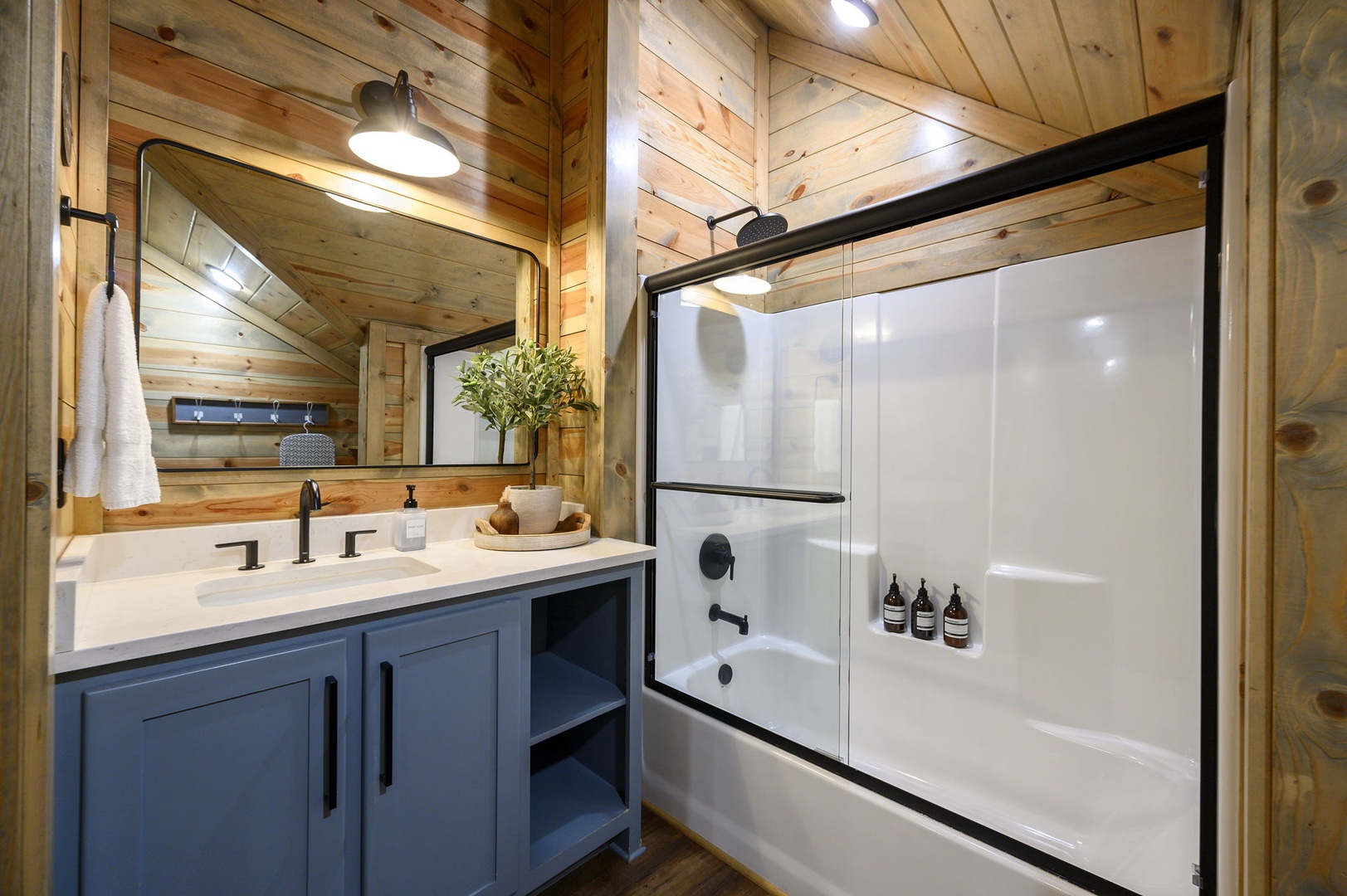 Refresh in your private modern bathroom, complete with a spacious tub and sleek vanity. Warm wood paneling and thoughtful touches create a cozy, spa-like retreat after your adventures.