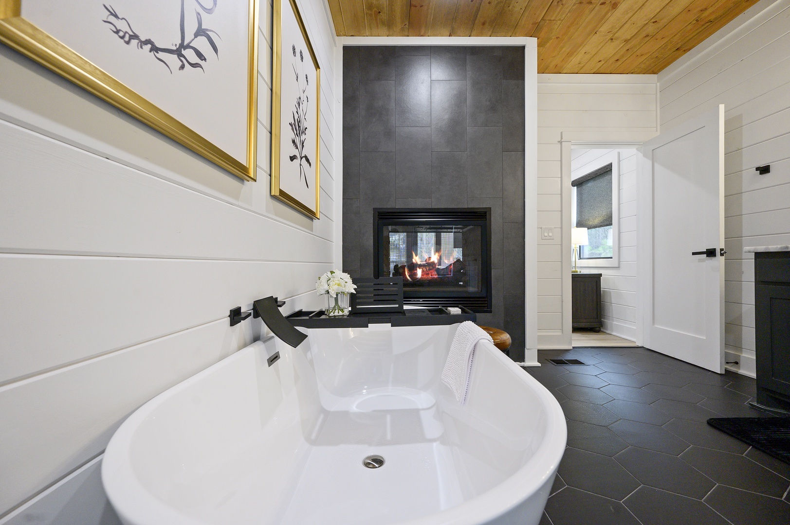Soak in your elegant freestanding tub while enjoying the warmth of a cozy fireplace—perfect for romantic evenings or peaceful moments.