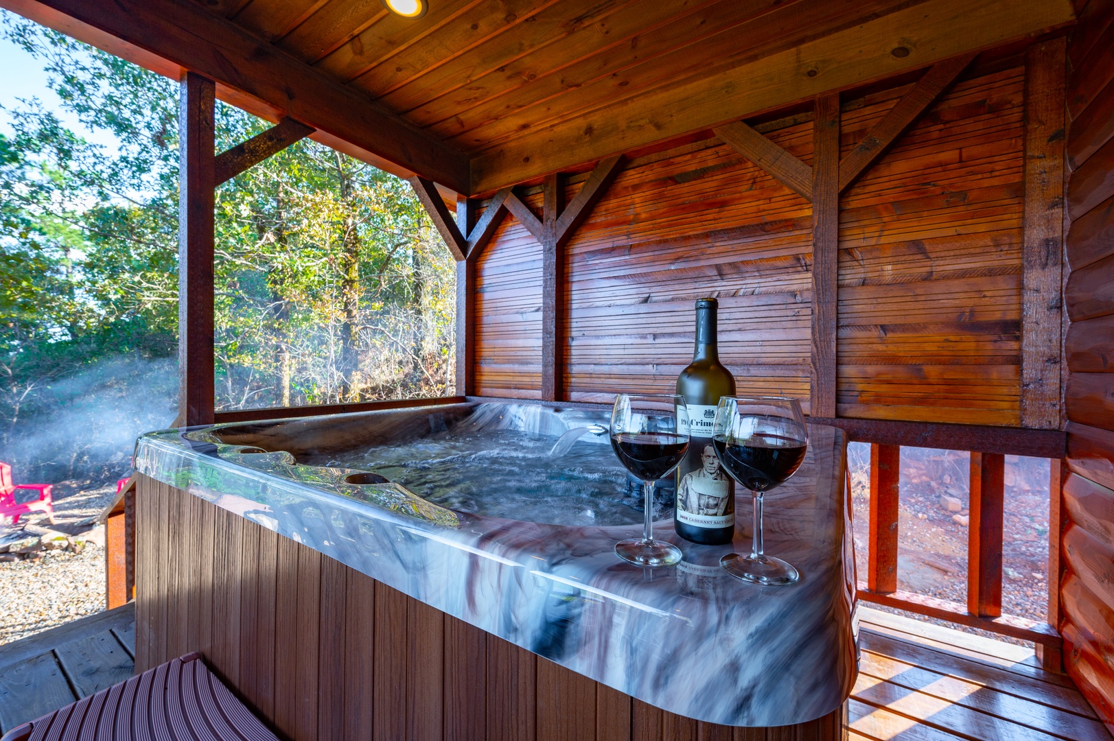 Unwind in your private hot tub sanctuary, where warm bubbles and fine wine create the perfect evening escape.