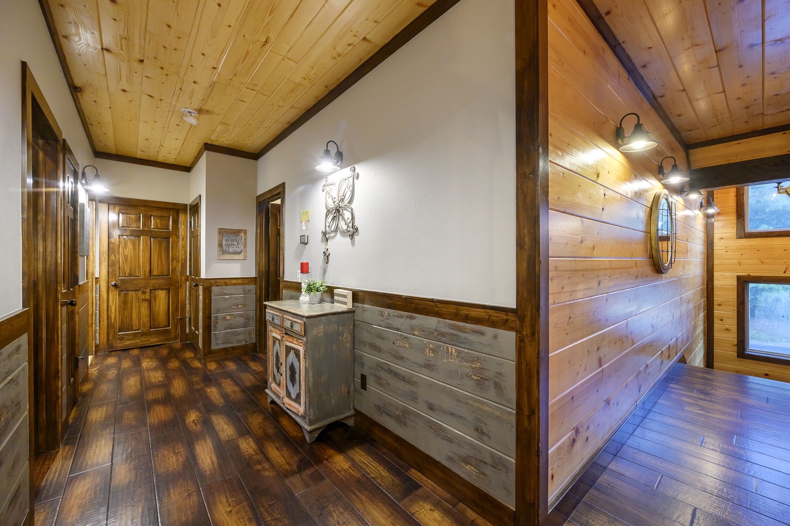 Step into a warm cabin retreat with polished wood floors, exposed beams, and rustic vintage furnishings welcoming you to your mountain escape.