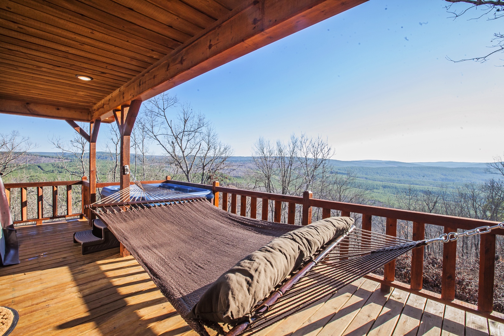 Sway gently in your private hammock while soaking in breathtaking mountain vistas from your covered deck retreat.