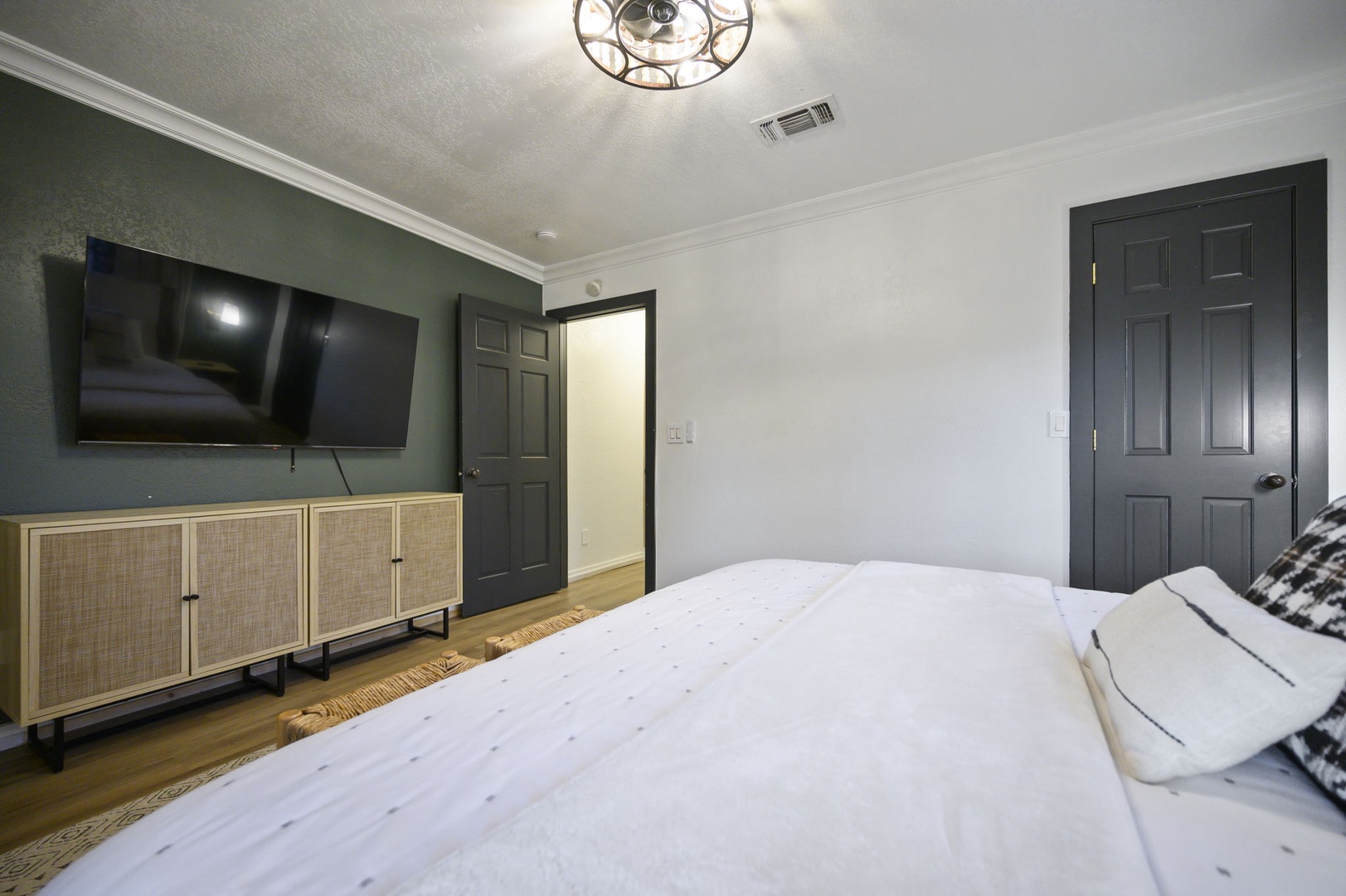 Unwind in your stylish bedroom featuring crisp linens, modern entertainment, and thoughtful design touches for ultimate relaxation.