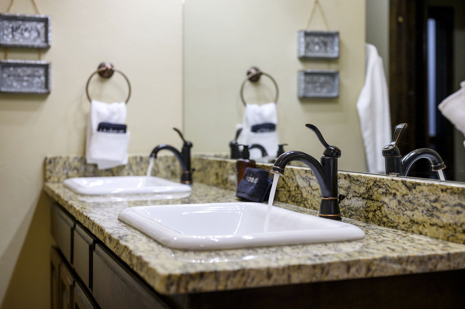 Fresh towels await you in this well-appointed bathroom, where granite counters and elegant fixtures set a refined, comfortable tone for your stay.