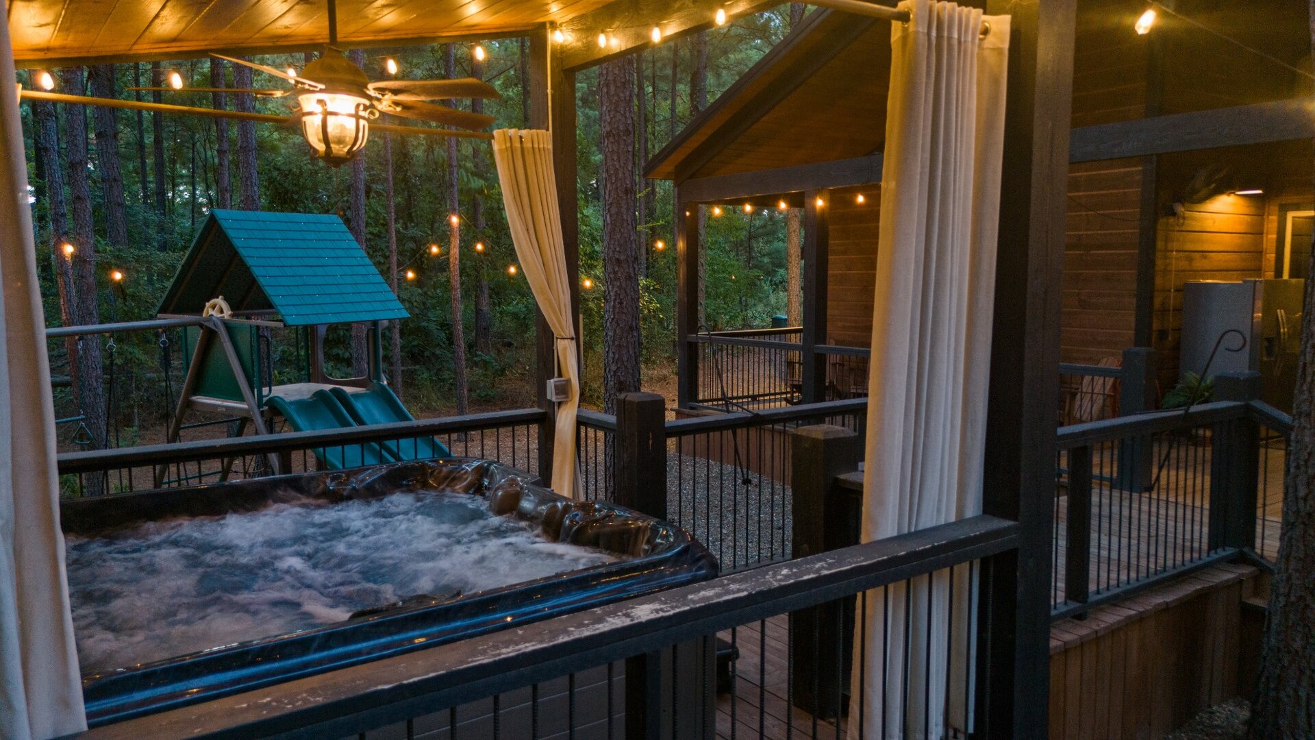 Sink into your private hot tub under twinkling lights, surrounded by towering pines and cool evening air. A magical forest escape awaits just steps from your door.