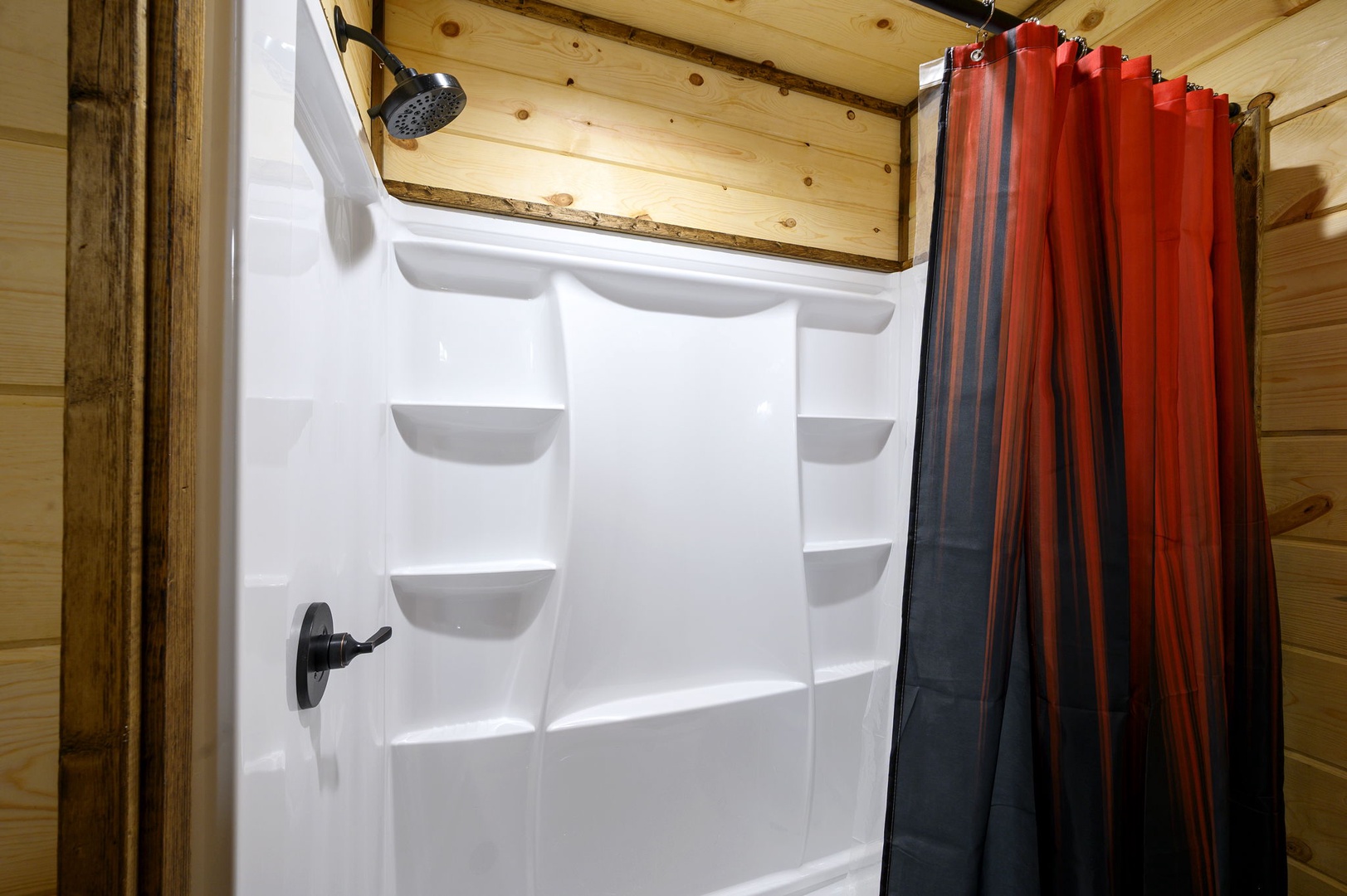 Spacious shower with convenient built-in shelving.