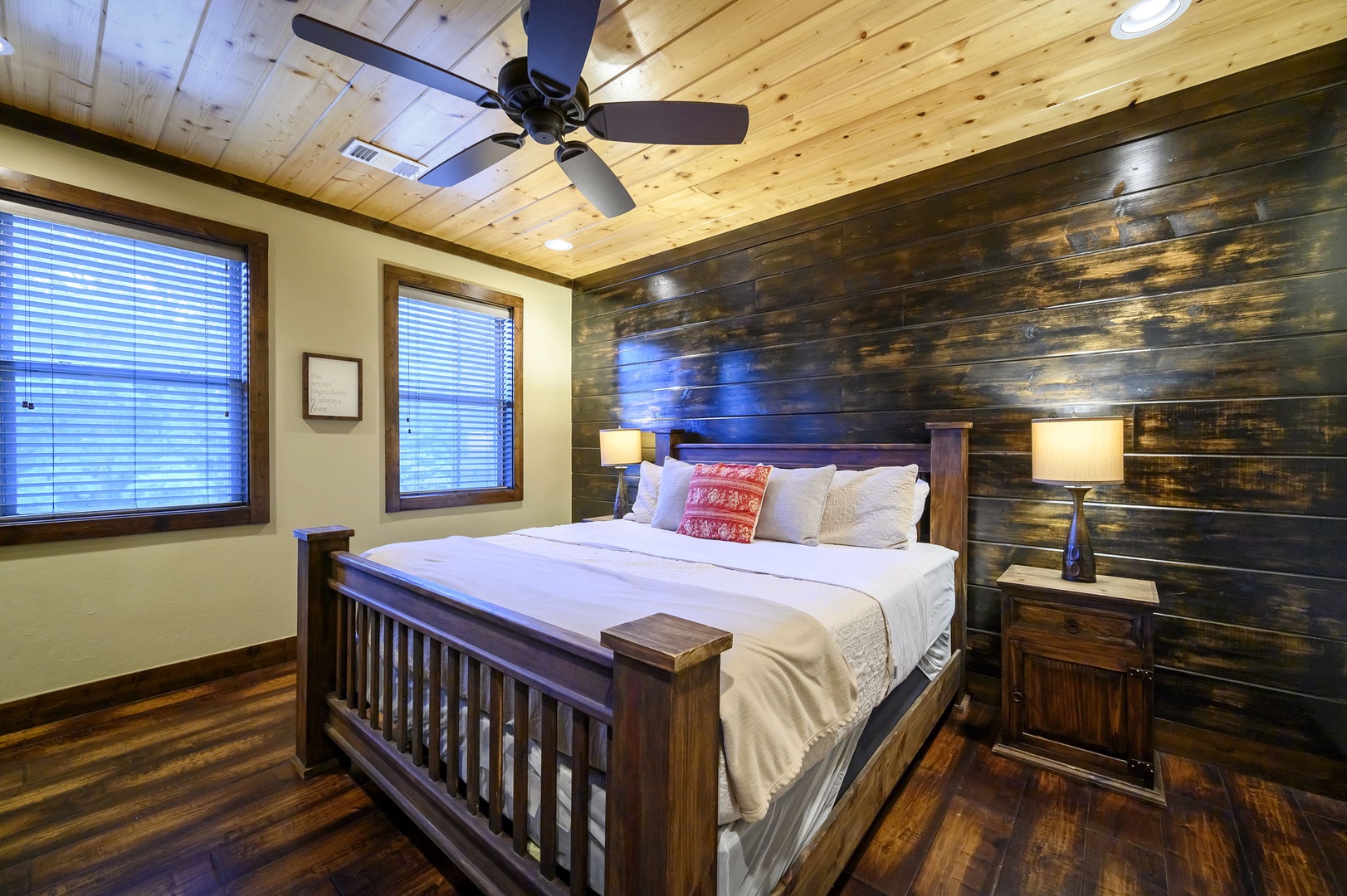 Sink into comfort in your cozy bedroom with rustic wood accents, soft linens, and a relaxing wood-paneled accent wall. Natural light and a ceiling fan keep your retreat comfortable all year round.