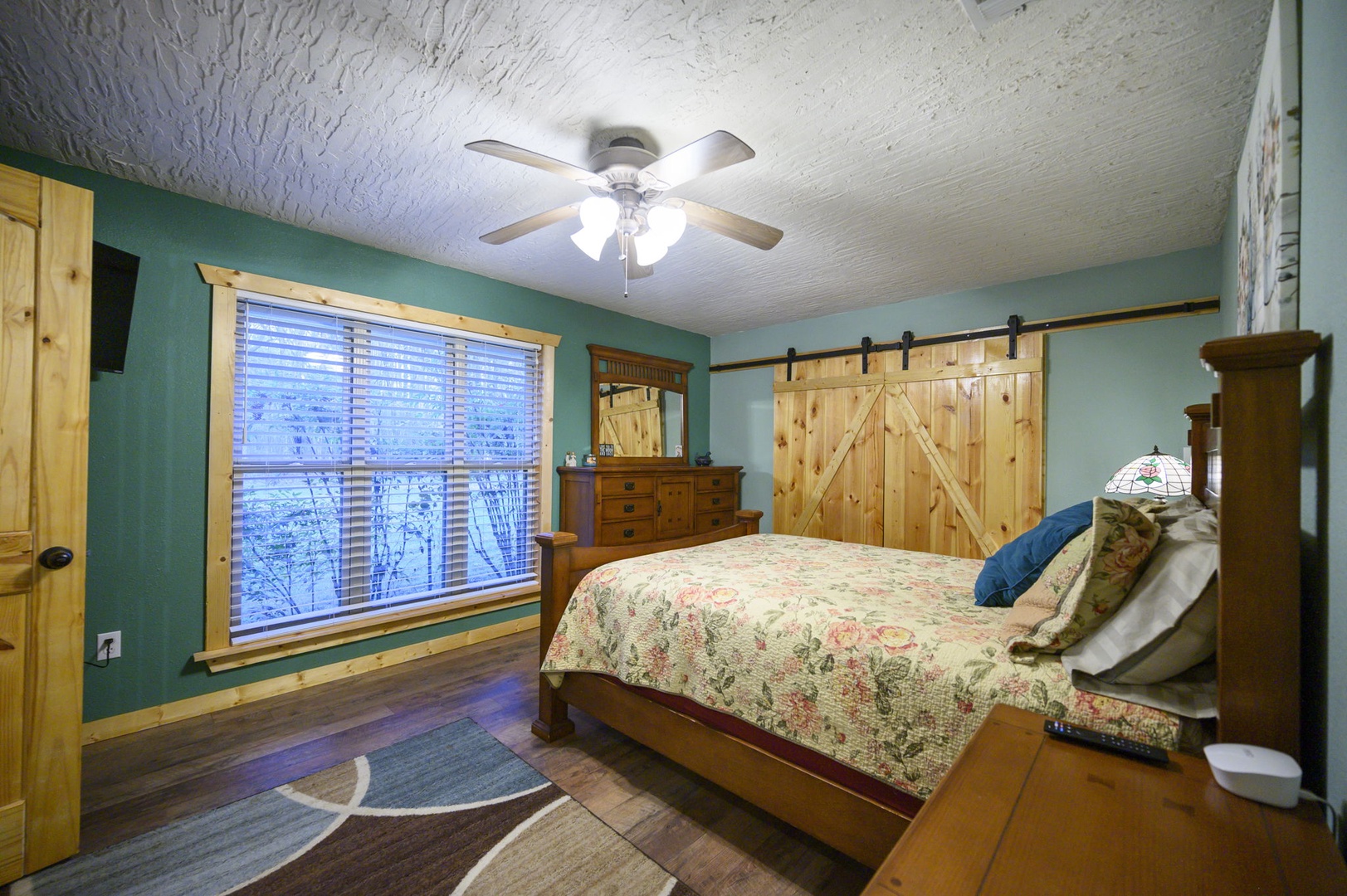 Cozy rustic bedroom with barn doors and charming wood details for your peaceful retreat.