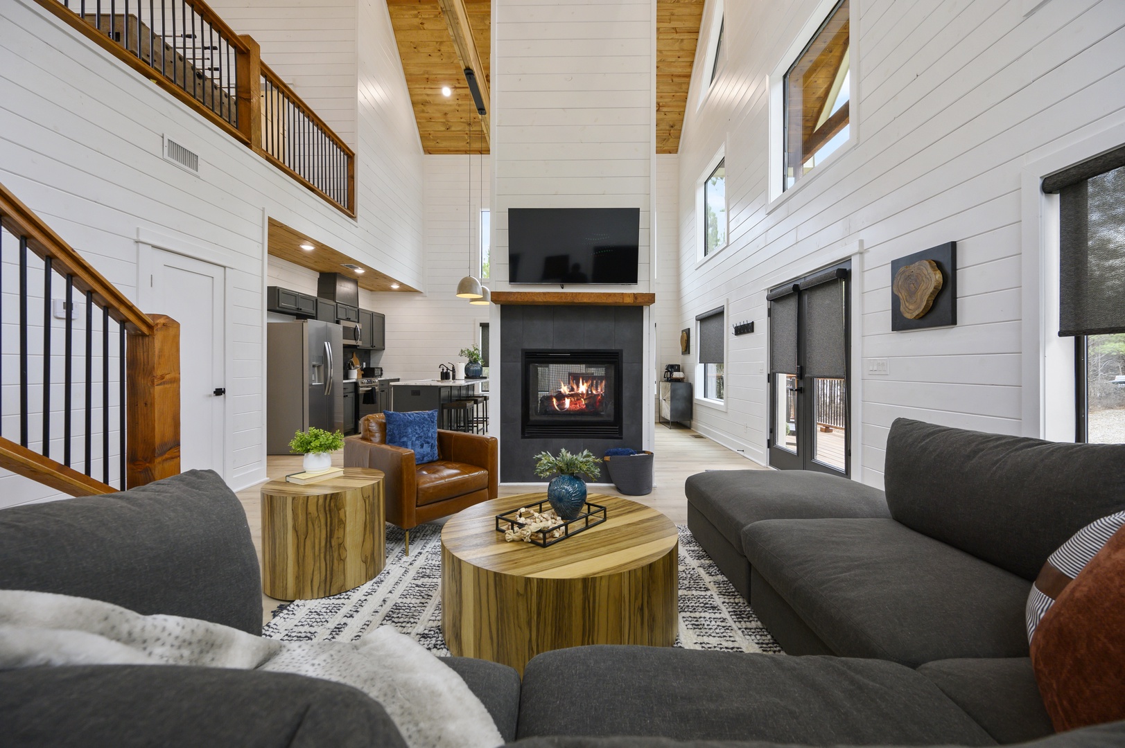 Unwind in your stunning great room where soaring ceilings, a crackling fireplace, and plush seating create the perfect retreat.