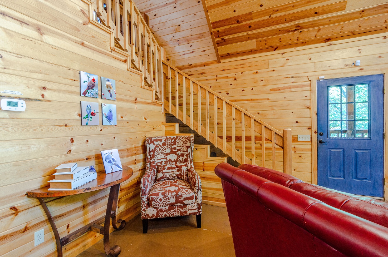 Unwind in your cozy cabin living area, where warm wood tones and comfortable seating create the perfect retreat after a day of adventure.