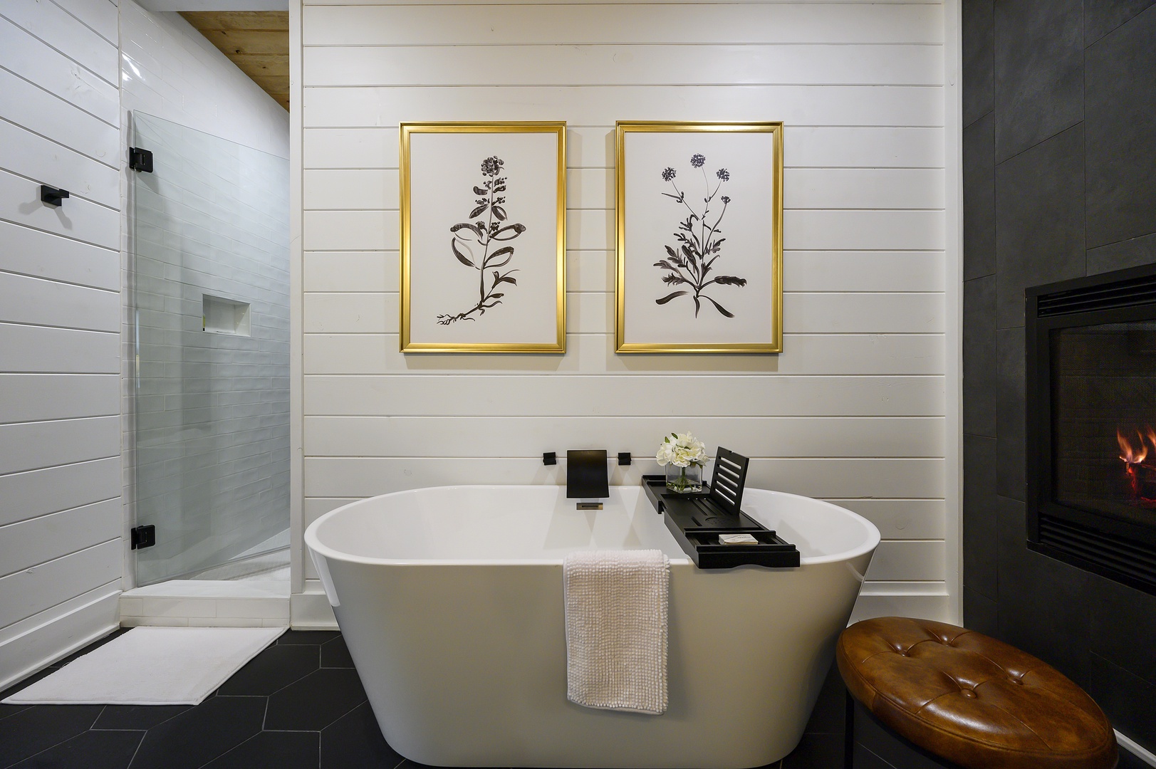 Soak away stress in your elegant freestanding tub, surrounded by botanical artwork and cozy firelight for pure relaxation.