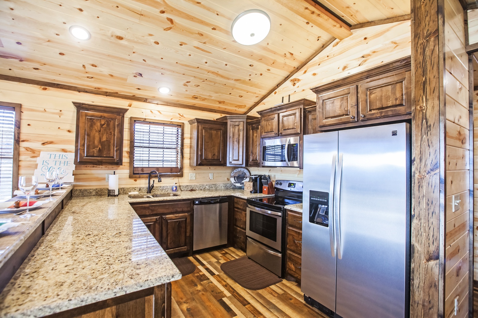 Cook your favorite meals in this stunning rustic kitchen with granite counters, stainless appliances, and warm wood beams overhead.