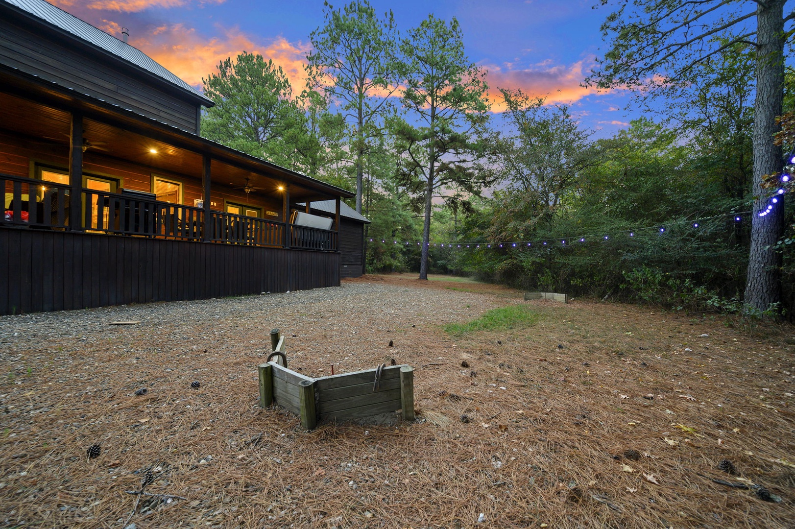 Cozy cabin nestled among towering pines with a fire pit perfect for evening gatherings under the stars.