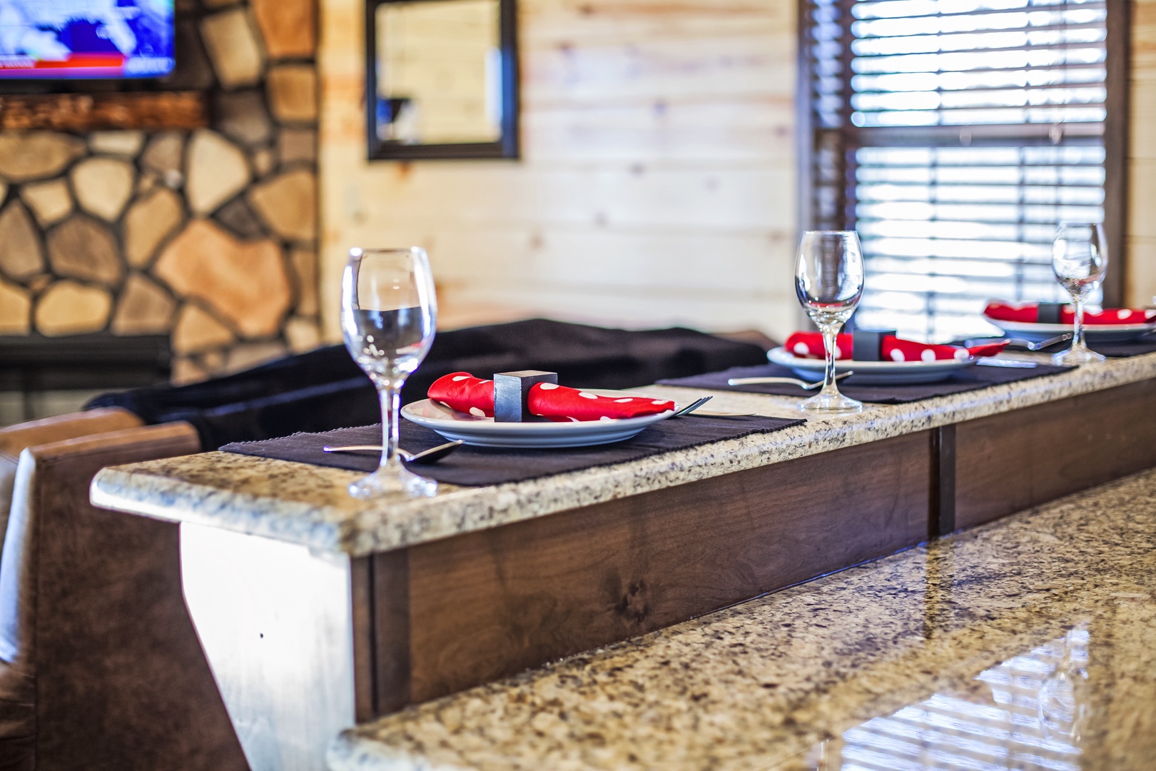 Savor intimate meals at your elegant granite bar with sparkling wine glasses and stylish place settings.