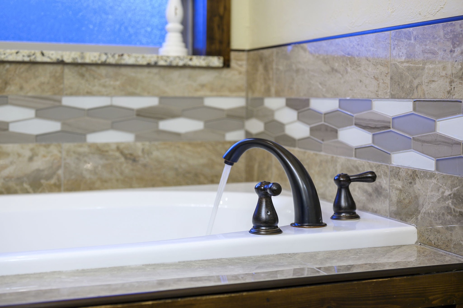 Sink into relaxation in your private soaking tub, where flowing water and elegant fixtures invite you to unwind after a day of adventure.