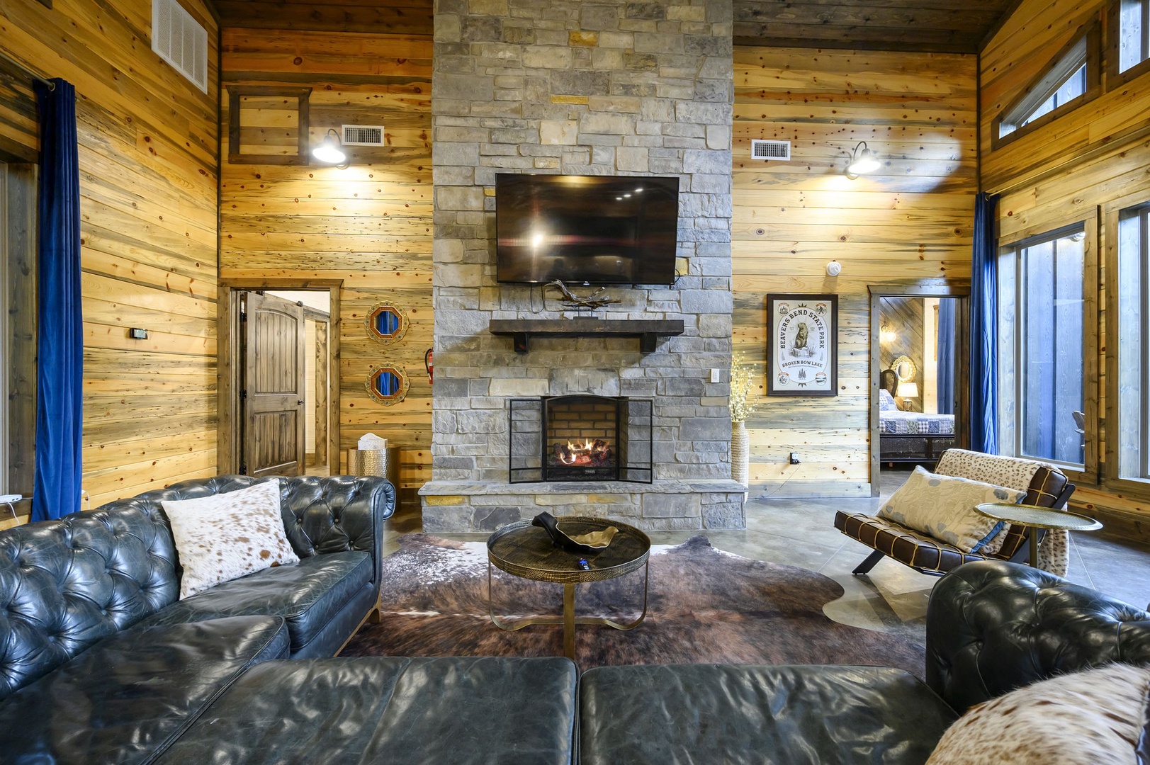 Sink into rich leather seating beside a glowing stone fireplace, framed by soaring pine ceilings that bring the warmth of the wilderness right to your door.