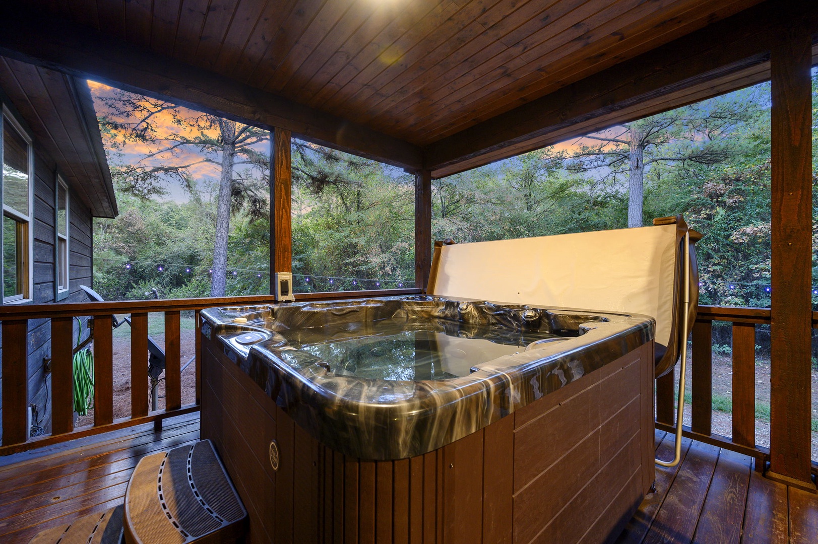 Soak away the day in your private hot tub, nestled on a screened terrace surrounded by towering pines and peaceful forest views—pure relaxation awaits.