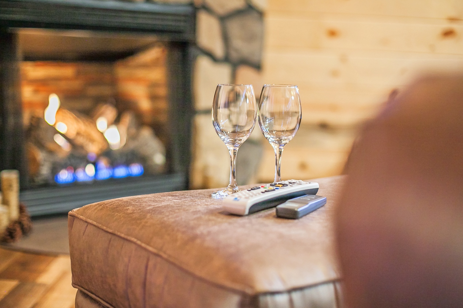 Settle into your cozy evening with wine glasses ready by the crackling fireplace, where warmth and relaxation await your perfect getaway.