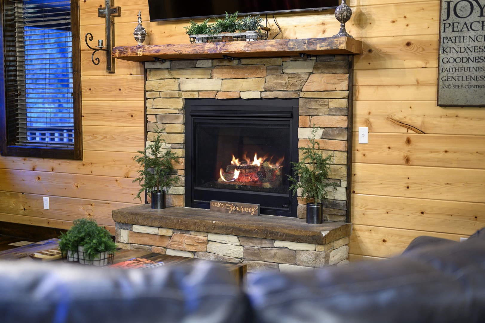 Curl up beside your cozy stone fireplace, where flickering flames and warm wood walls create the perfect retreat after a day of adventure.