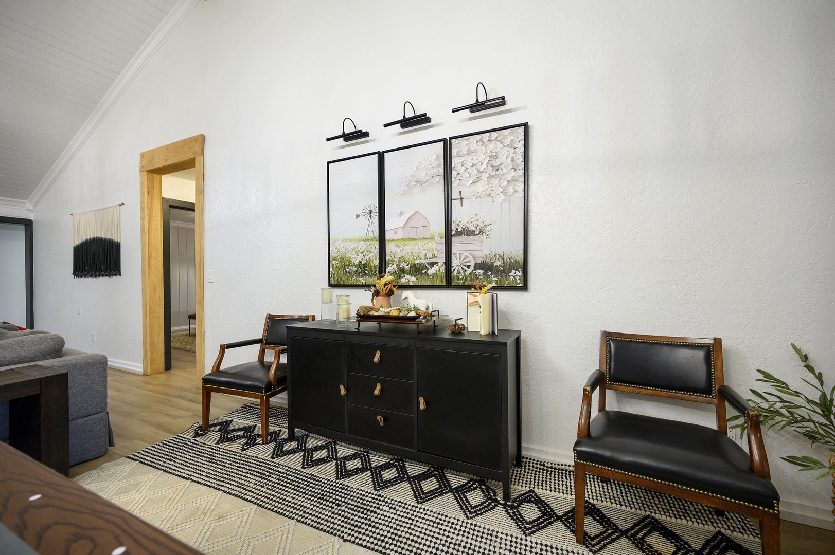 Unwind in your stylish living space, where warm wood accents and carefully curated art create the perfect atmosphere for relaxation.