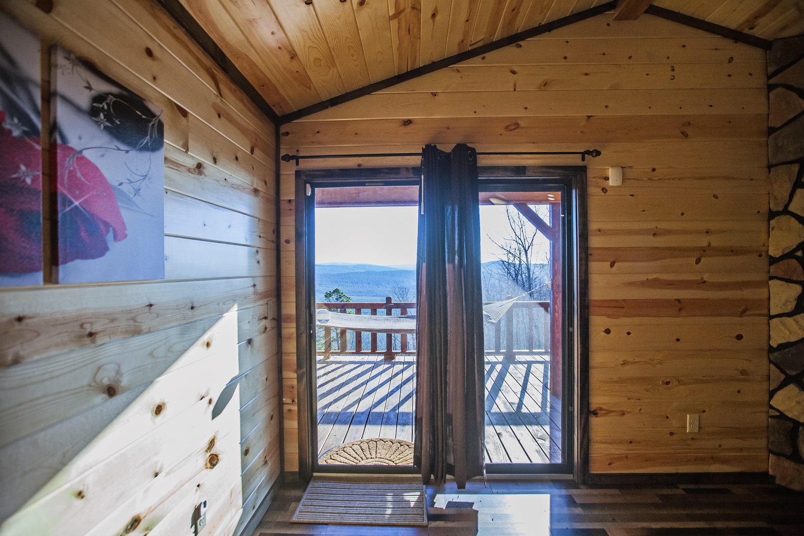 Step onto your private deck through these glass doors and breathe in stunning mountain views from your cozy log cabin retreat.