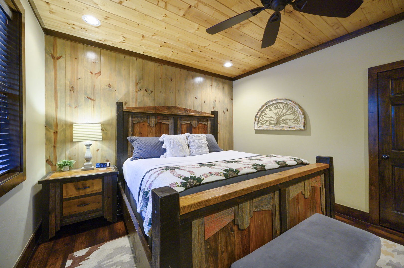 Your rustic retreat features a handcrafted wooden bed with crisp linens, warm wood-paneled walls and ceiling, and a ceiling fan to keep you comfortable year-round.