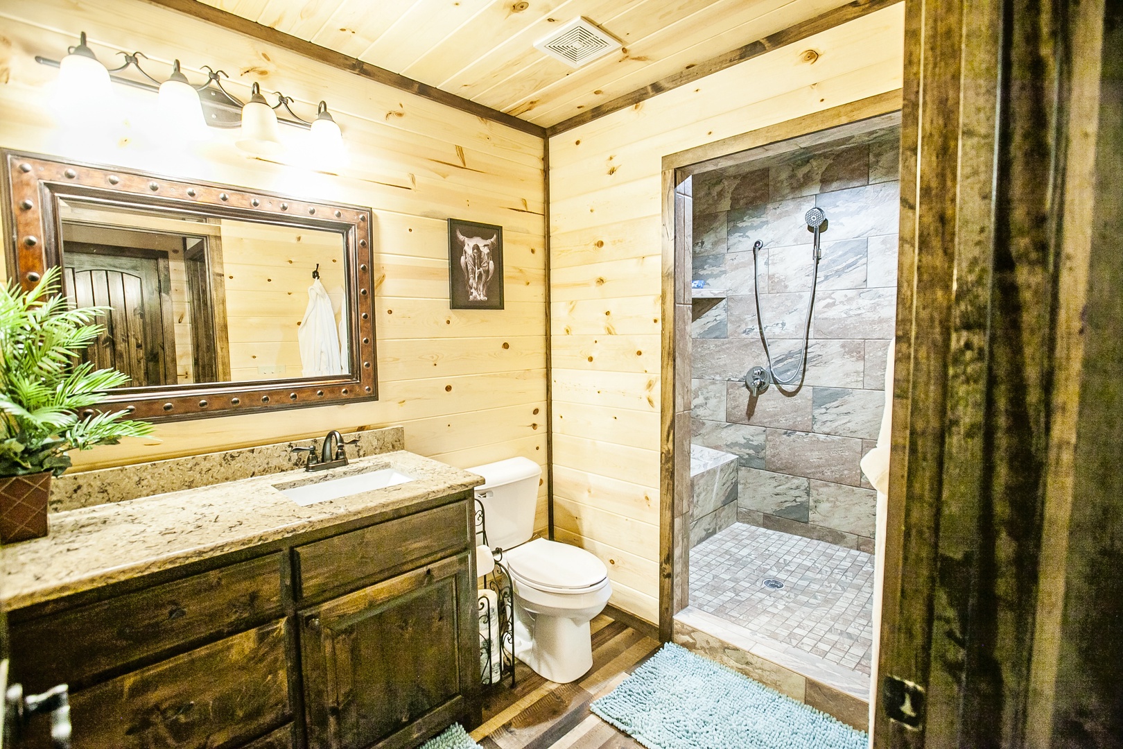 Your private rustic bathroom features gorgeous stone shower, granite counters, and warm cabin charm perfect for refreshing after mountain adventures.