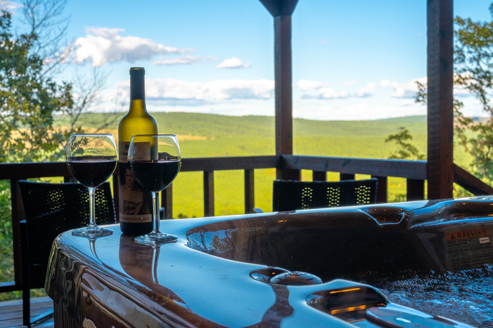 Soak in your private hot tub with wine as rolling green hills stretch endlessly before you—pure bliss awaits.