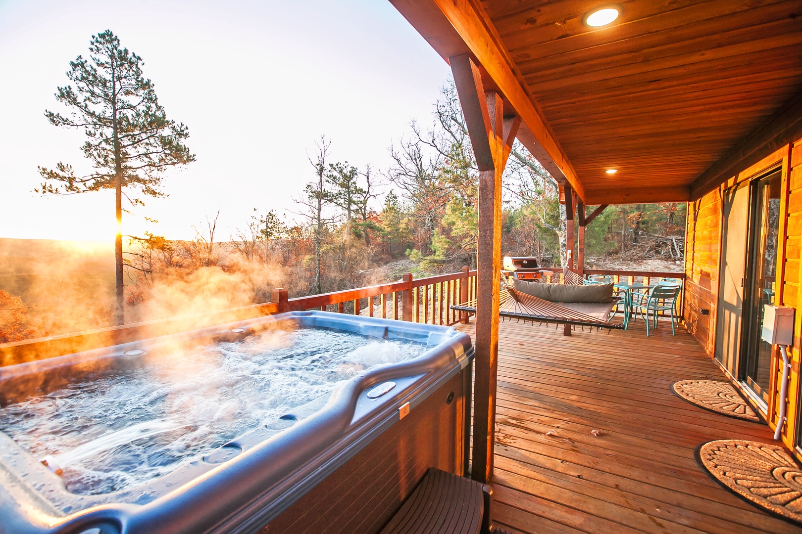 Soak in your private hot tub as golden light filters through the trees, creating the perfect mountain retreat moment.