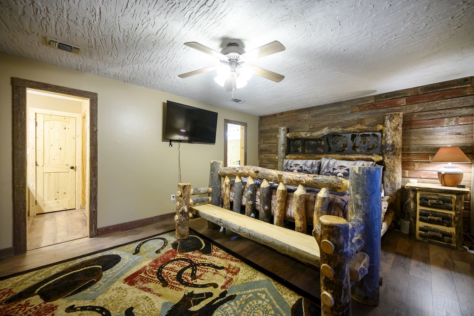 Sleep surrounded by rustic charm in your log-style bedroom, complete with handcrafted furniture, modern amenities, and cozy mountain lodge ambiance.