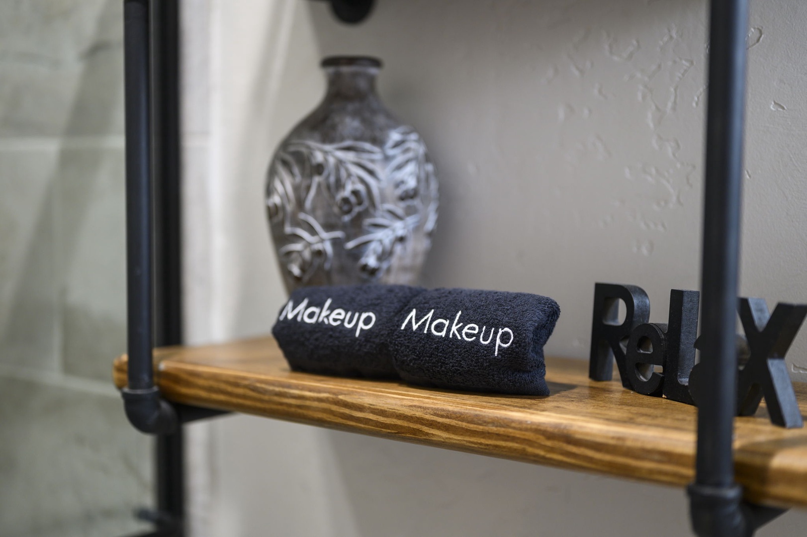 Your bathroom shelf is thoughtfully styled with plush makeup towels and decorative touches that add warmth and character to your morning routine.