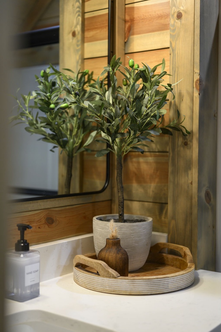 Step into your private bathroom where warm wood tones and thoughtful touches create a spa-like retreat you'll look forward to each morning.