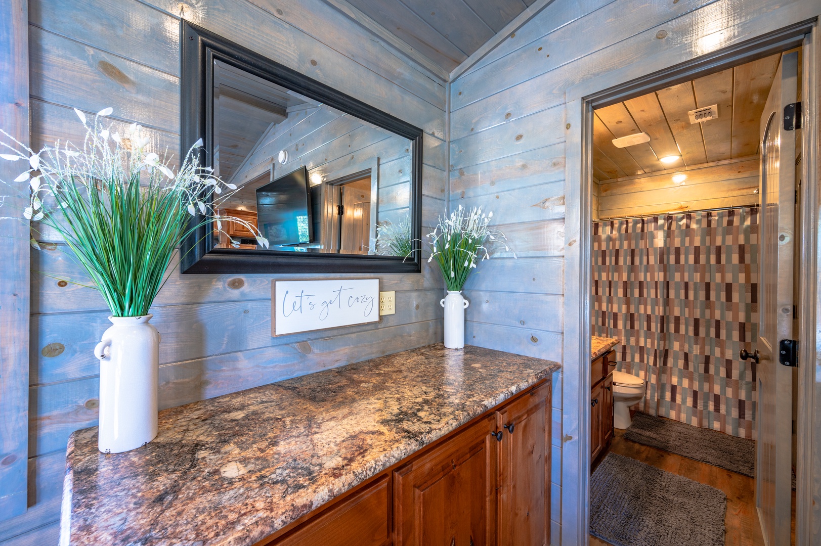 Your private bathroom blends rustic charm with modern comfort, featuring rich granite counters and spa-inspired design details for your relaxation.
