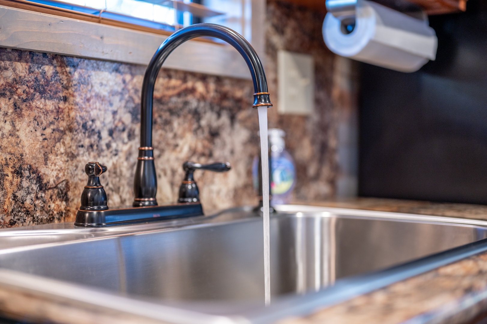 Your well-appointed kitchen features a sleek stainless steel sink with elegant granite countertops, perfect for preparing meals during your stay.