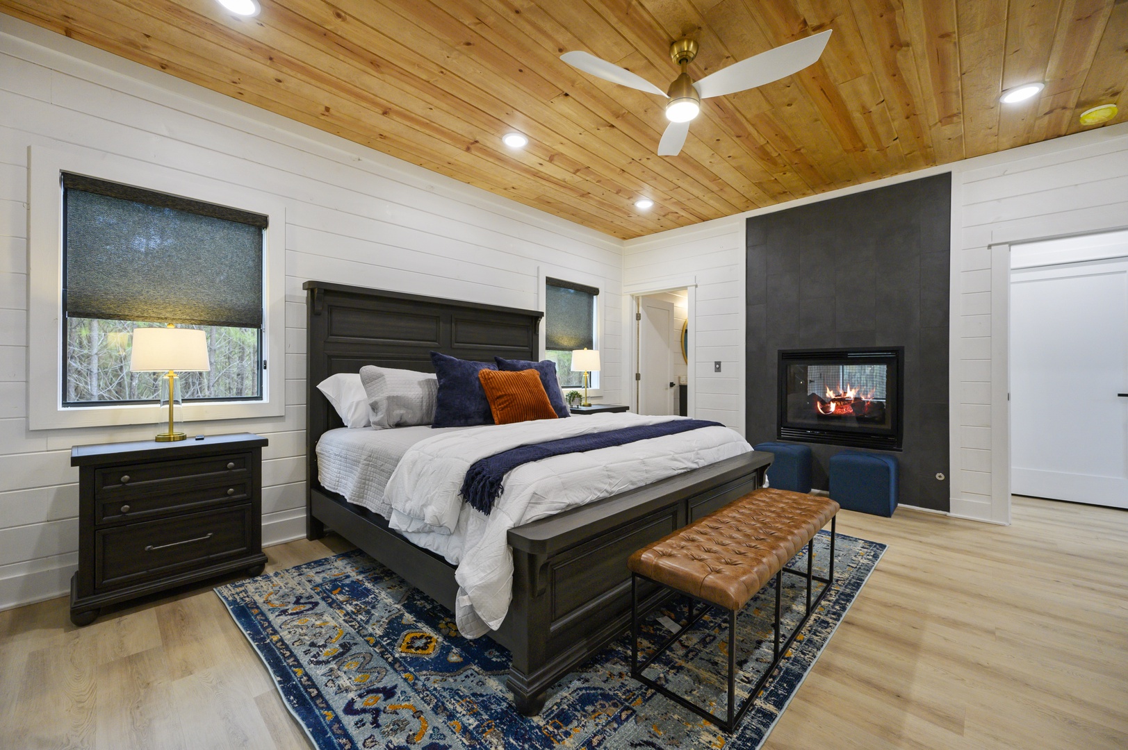 Your cozy bedroom features a crackling fireplace and exposed wood ceiling, creating the perfect atmosphere for peaceful nights.