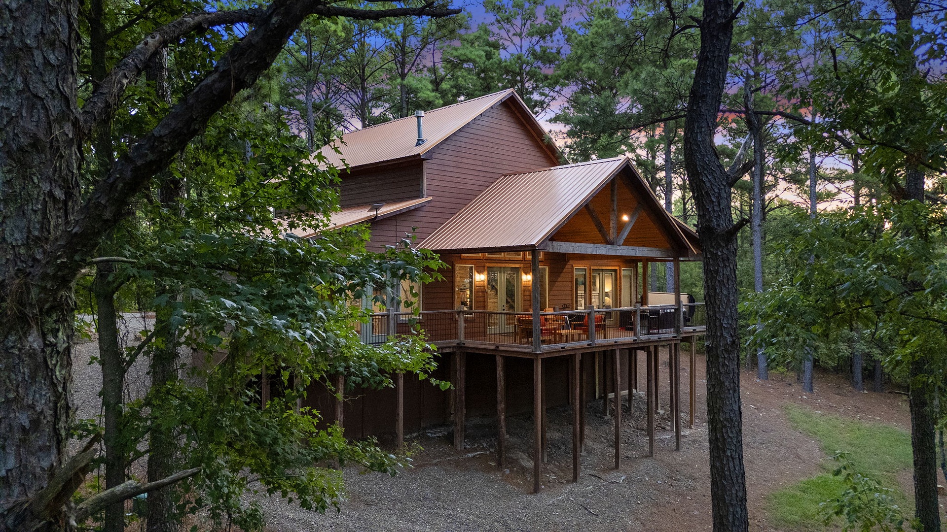 Nestled among tall pines, this charming cabin offers a private woodland retreat with a welcoming covered porch—your peaceful escape awaits.