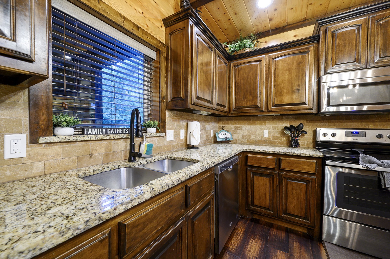 Your fully equipped kitchen features rich wood cabinetry, granite counters, and stainless appliances, making it easy to prepare meals in this warm, mountain-inspired space.