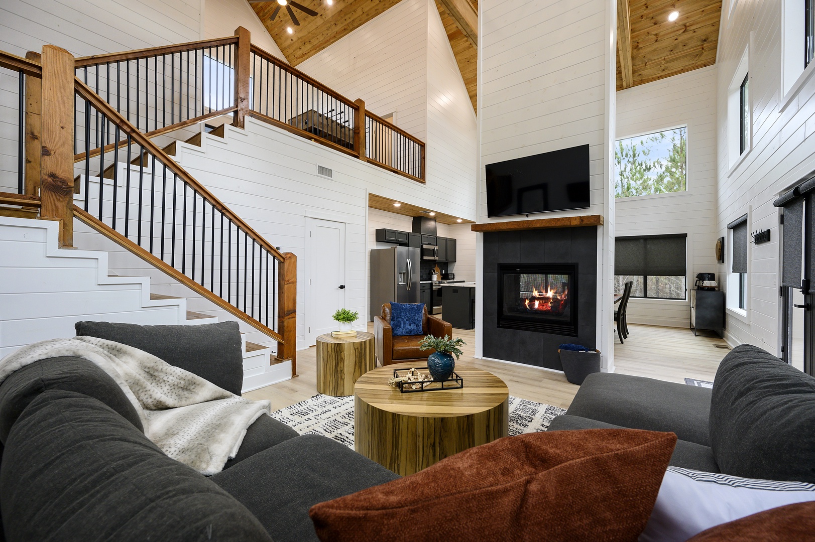 Sink into plush sofas by the crackling fireplace while soaring ceilings and rustic beams create your perfect mountain retreat.