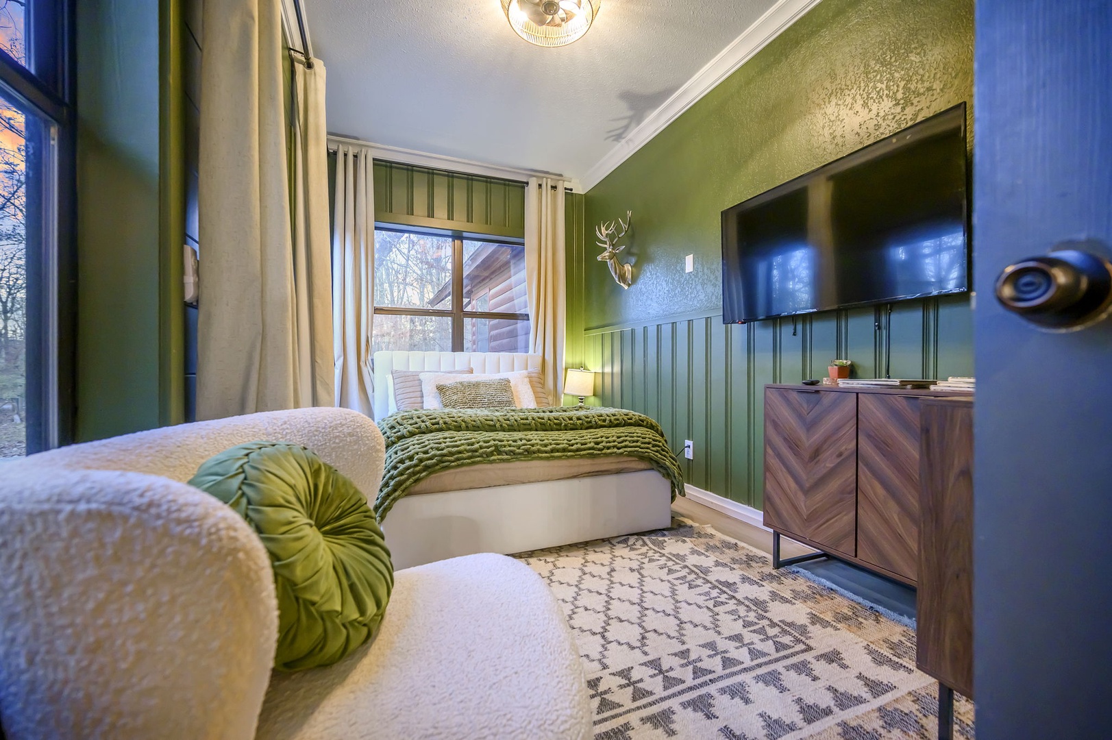 Sink into plush textures and calming green hues in your serene bedroom retreat, where comfort meets style.